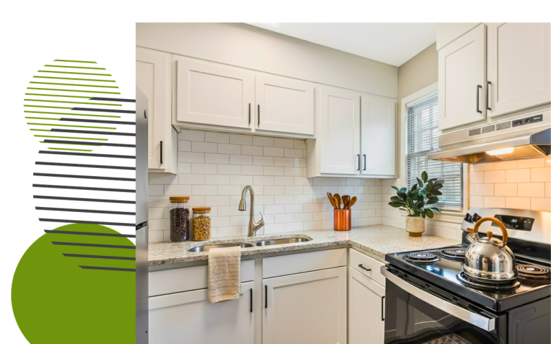 Renovated apartment kitchen at Retreat at Kannapolis in Kannapolis, NC featuring white shaker-style cabinets, subway tile backsplash, granite-style countertops, stainless steel range hood, and modern fixtures in a 1 and 2 bedroom apartment.
