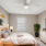 a bedroom with a ceiling fan and a bed